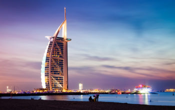 DUBAI, UAE - FEBRUARY 2018 :The world's first seven stars luxury hotel Burj Al Arab at night seen from Jumeirah public beach in Dubai, United Arab Emirates